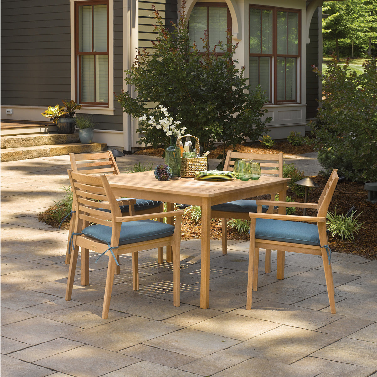Oxford Garden Mera 5-Piece Square 42 inch Dining Set shown set up in an outdoor setting