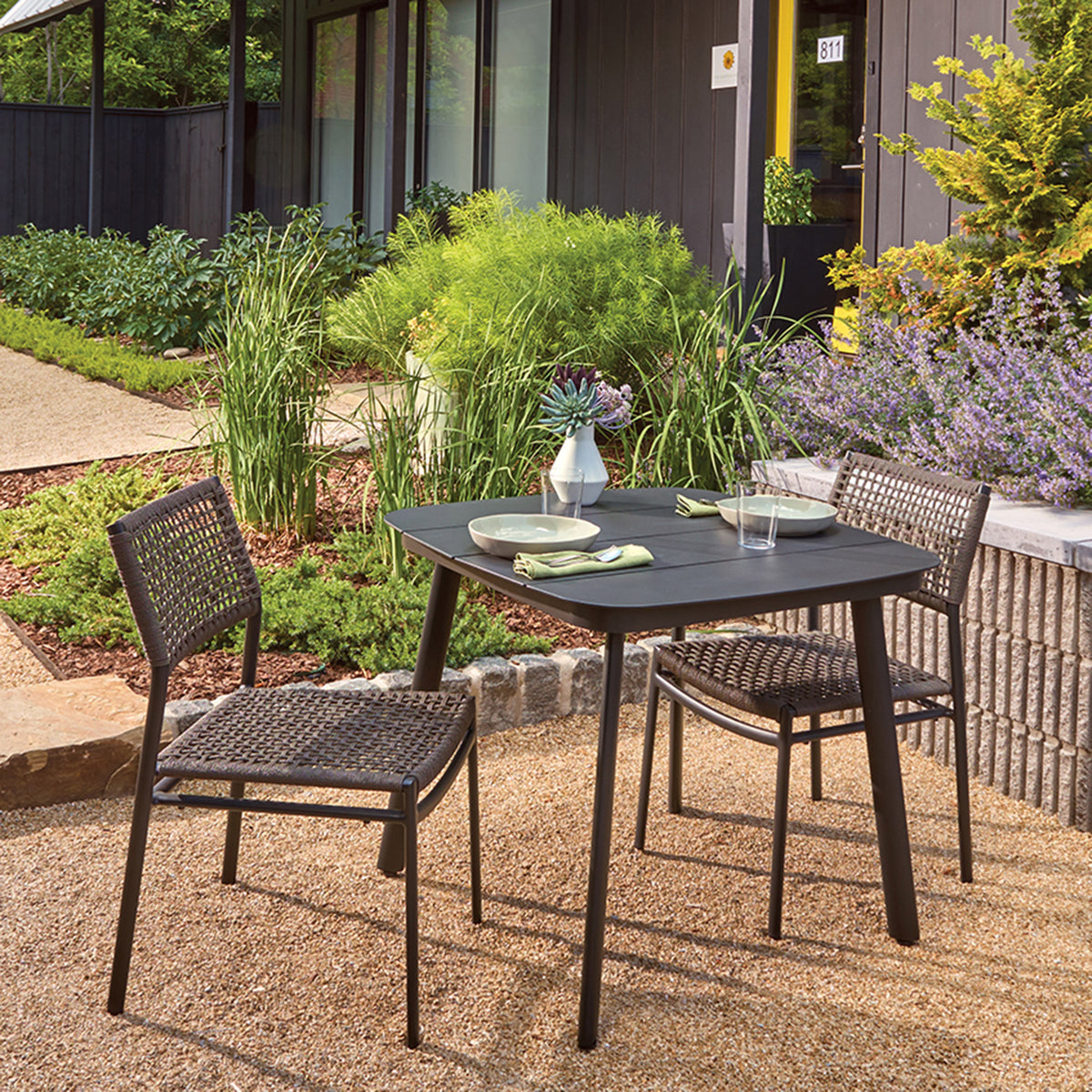 Oxford Garden Eiland 3-Piece Square 36 inch Dining Set shown set up in an outdoor setting