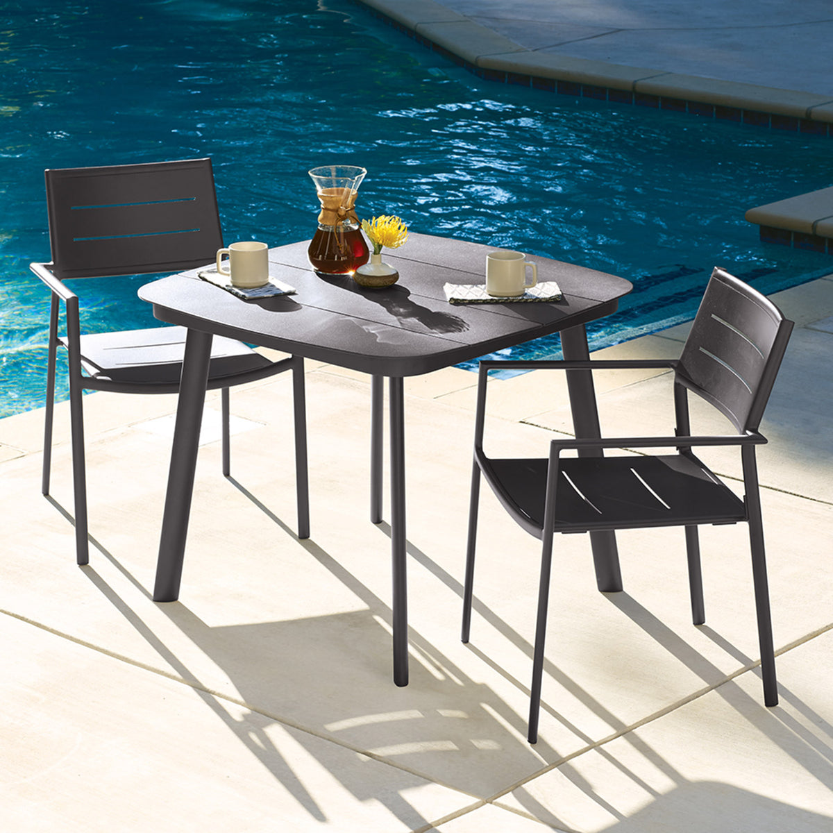 Oxford Garden Eiland Aluminum 3-Piece 36 inch Dining Set shown set up in an outdoor setting