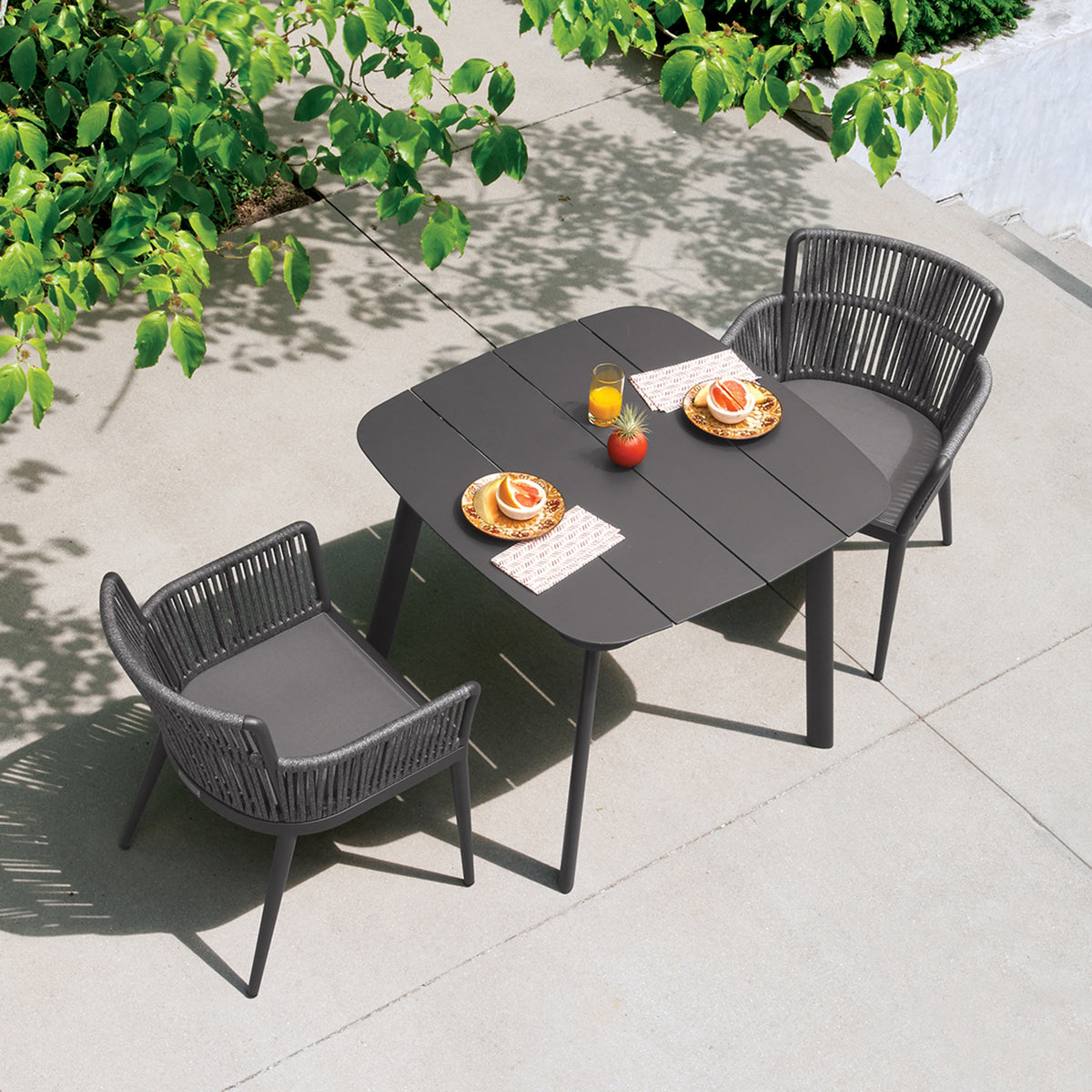 Oxford Garden Nette 3-Piece Square 36 inch Dining Set shown set up in an outdoor setting