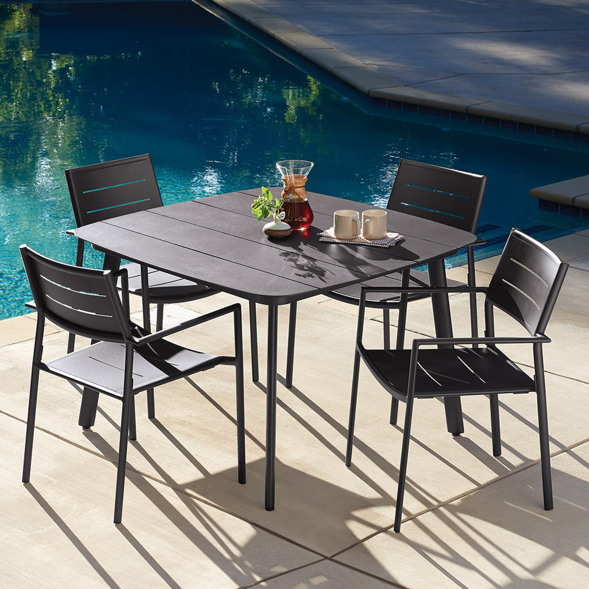 Oxford Garden Eiland 5-Piece 45 inch Dining Set, Carbon shown set up in an outdoor setting