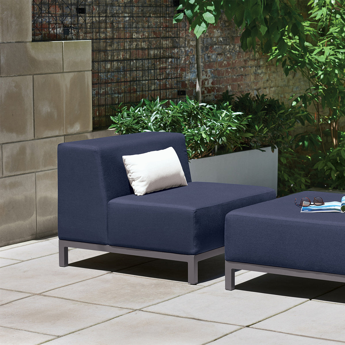 Oxford Garden Koral Modular Side Seat Upholstery shown in an outdoor setting