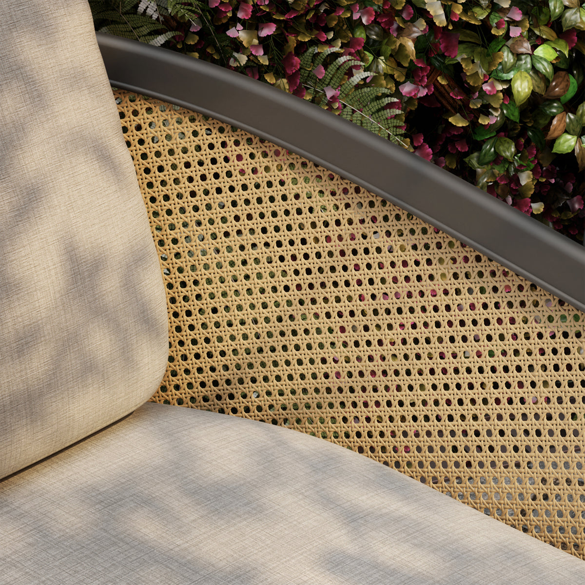 Detail of the Blonde Cane Weave wrapping the arm and back of the lounge chair