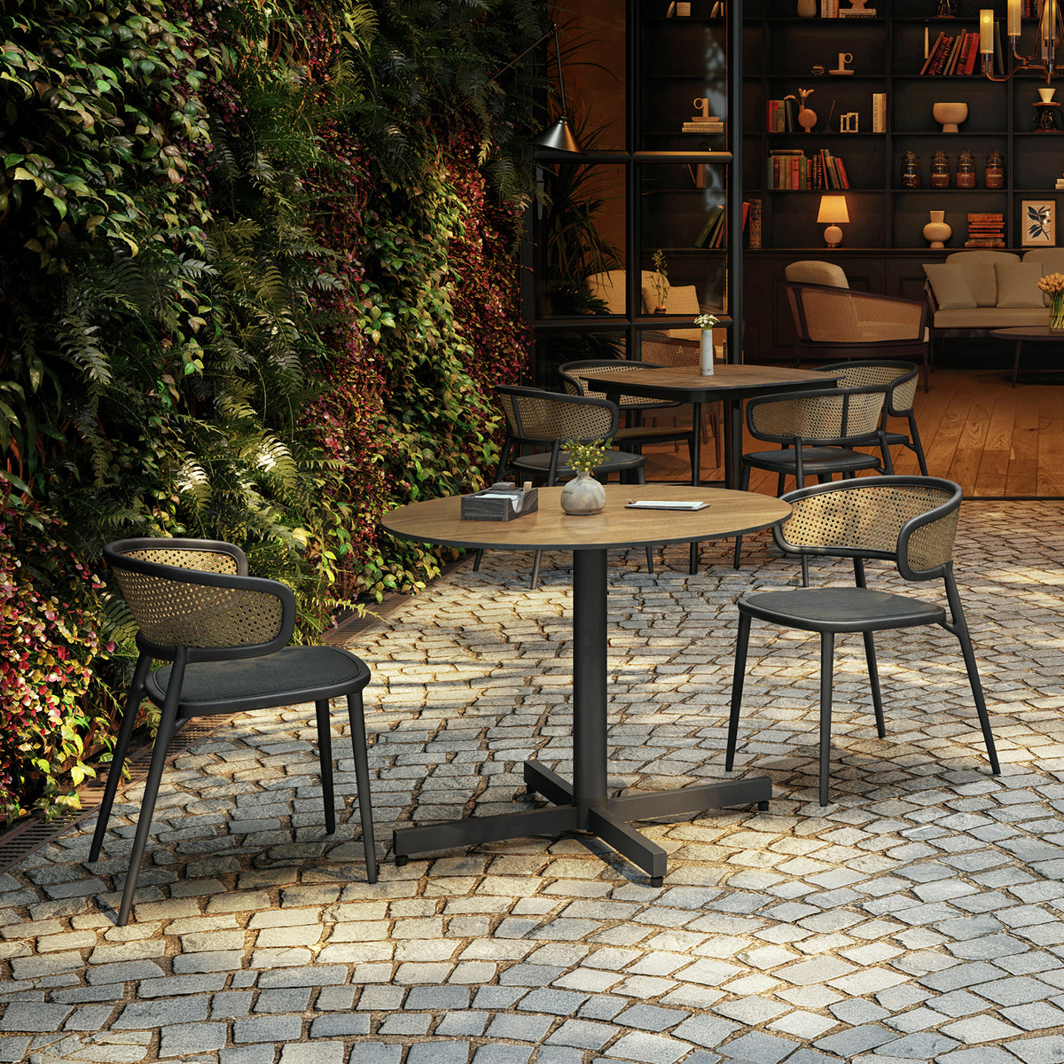 Oxford Garden Mena table set with Mende dining chairs on a paved terrace