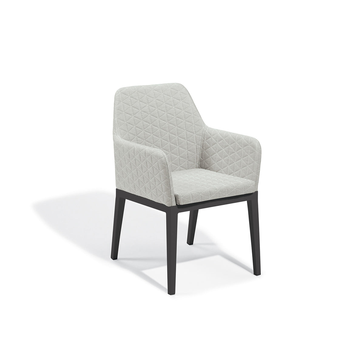 Quilted upholstered dining armchair in Canvas Granite on a Carbon powder coated aluminum frame, photographed on a plain white background