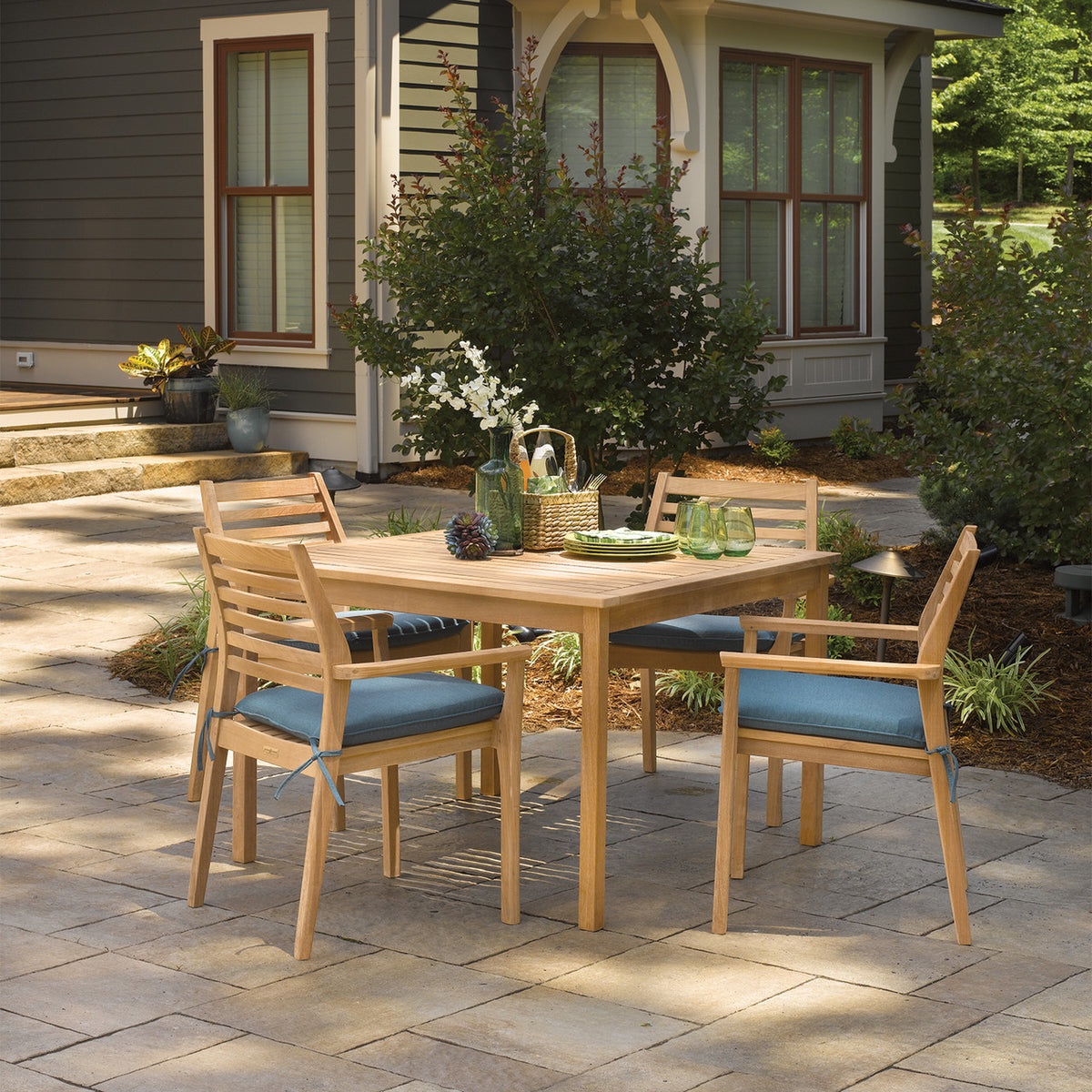 Oxford Garden Oxford Teak 42" Square Dining Table shown in an outdoor setting