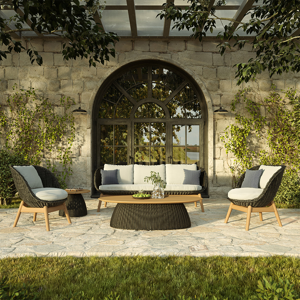 Teak topped low table among woven deep seating on a terrace