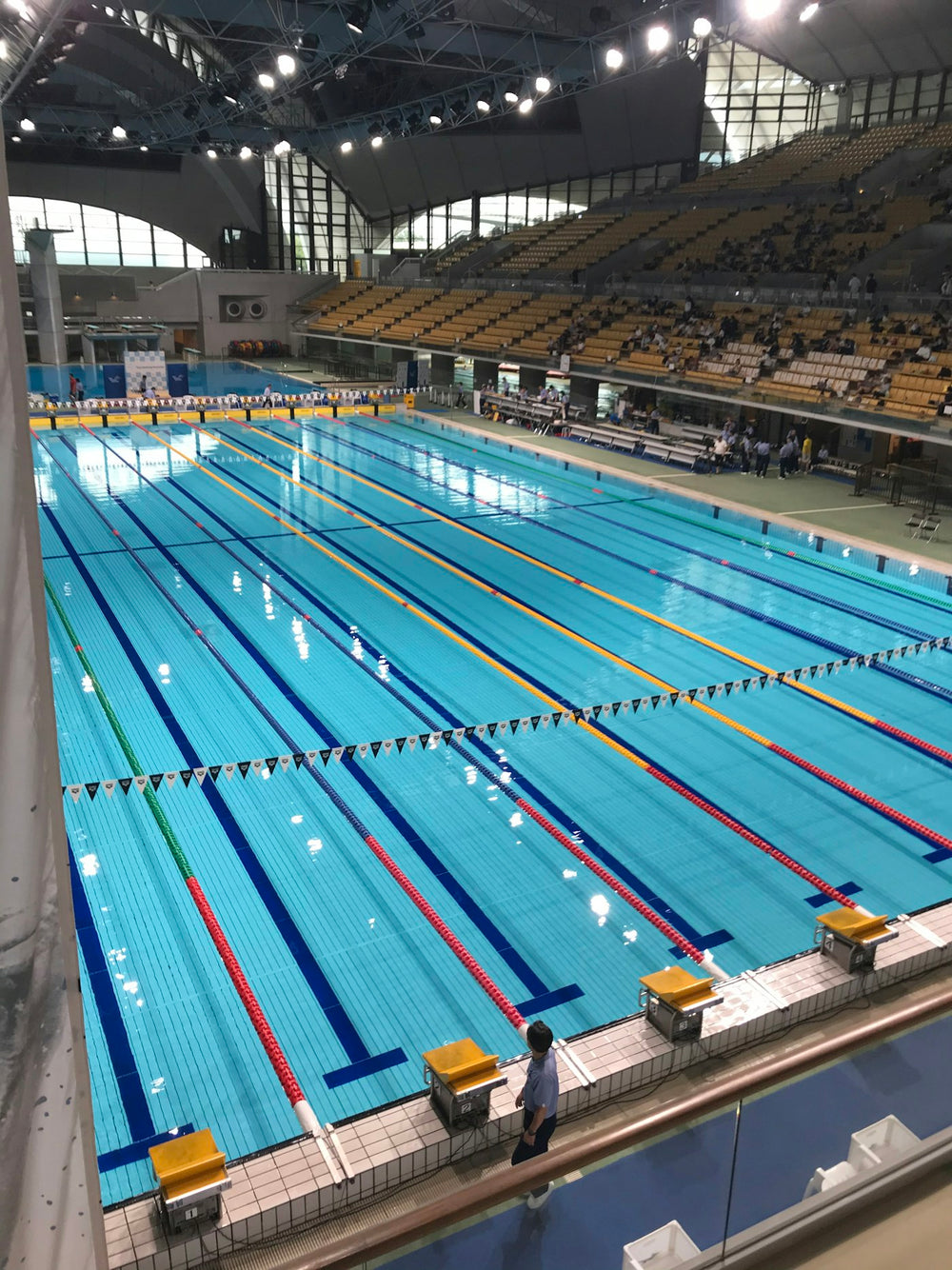 An empty competition pool with lane lines running its length
