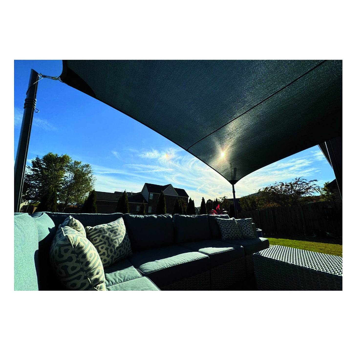 Underside of a shade sail tensioned between Tara Mod Shade poles over outdoor seating