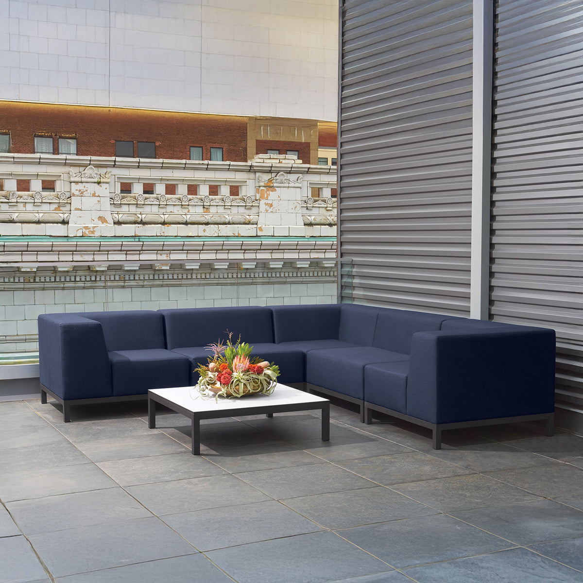 Oxford Garden Koral Modular Corner Seat Upholstery shown in an outdoor setting