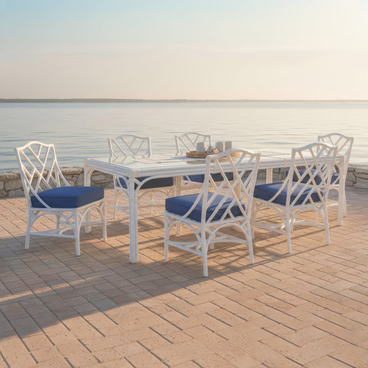 Chippendale outdoor side chairs around the matching dining table on a waterfront deck