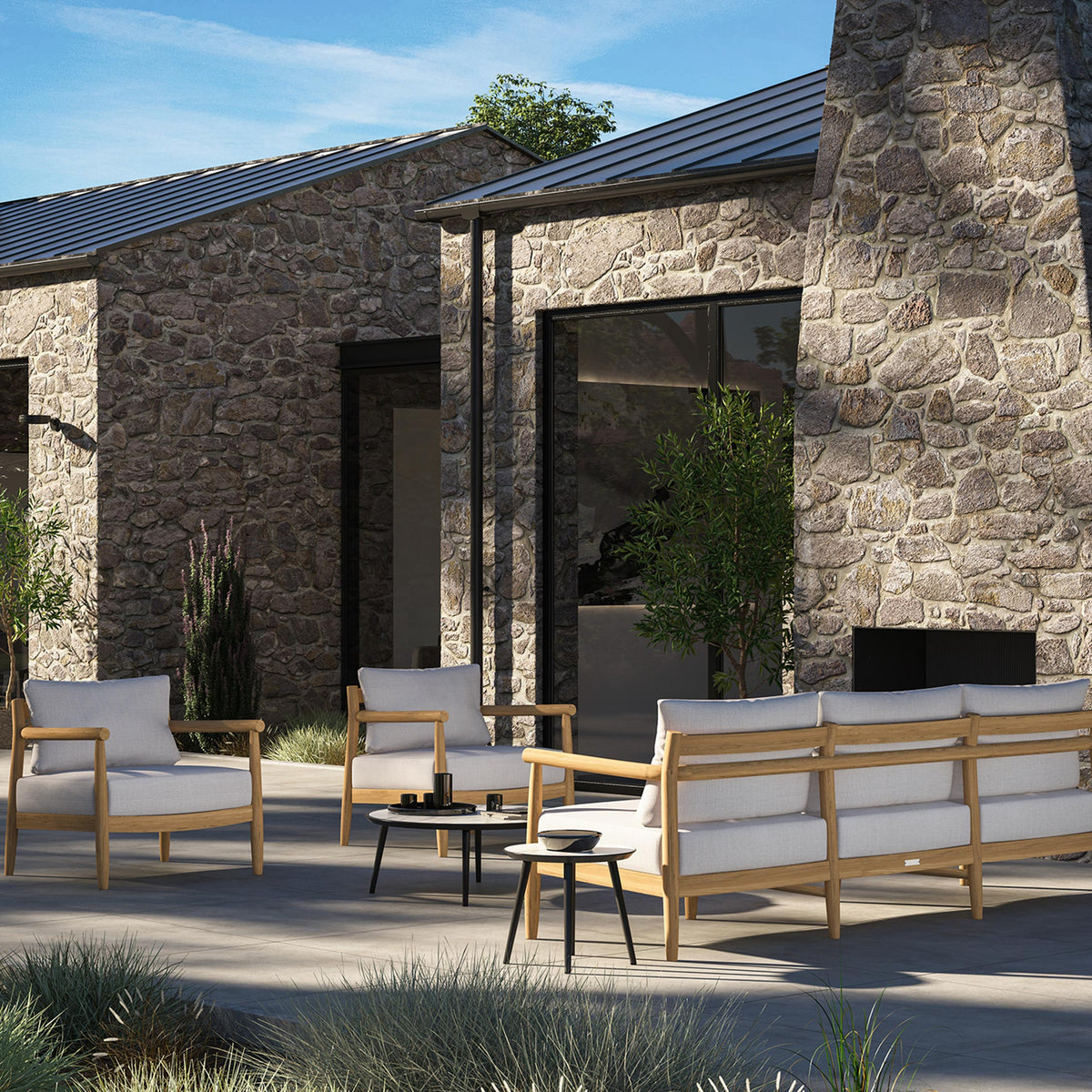Lido teak lounge group with deep seat and back cushions arranged on a terrace