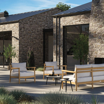 Full Lido teak collection arranged as an outdoor lounge group on a terrace, sofa with loveseat and club chairs