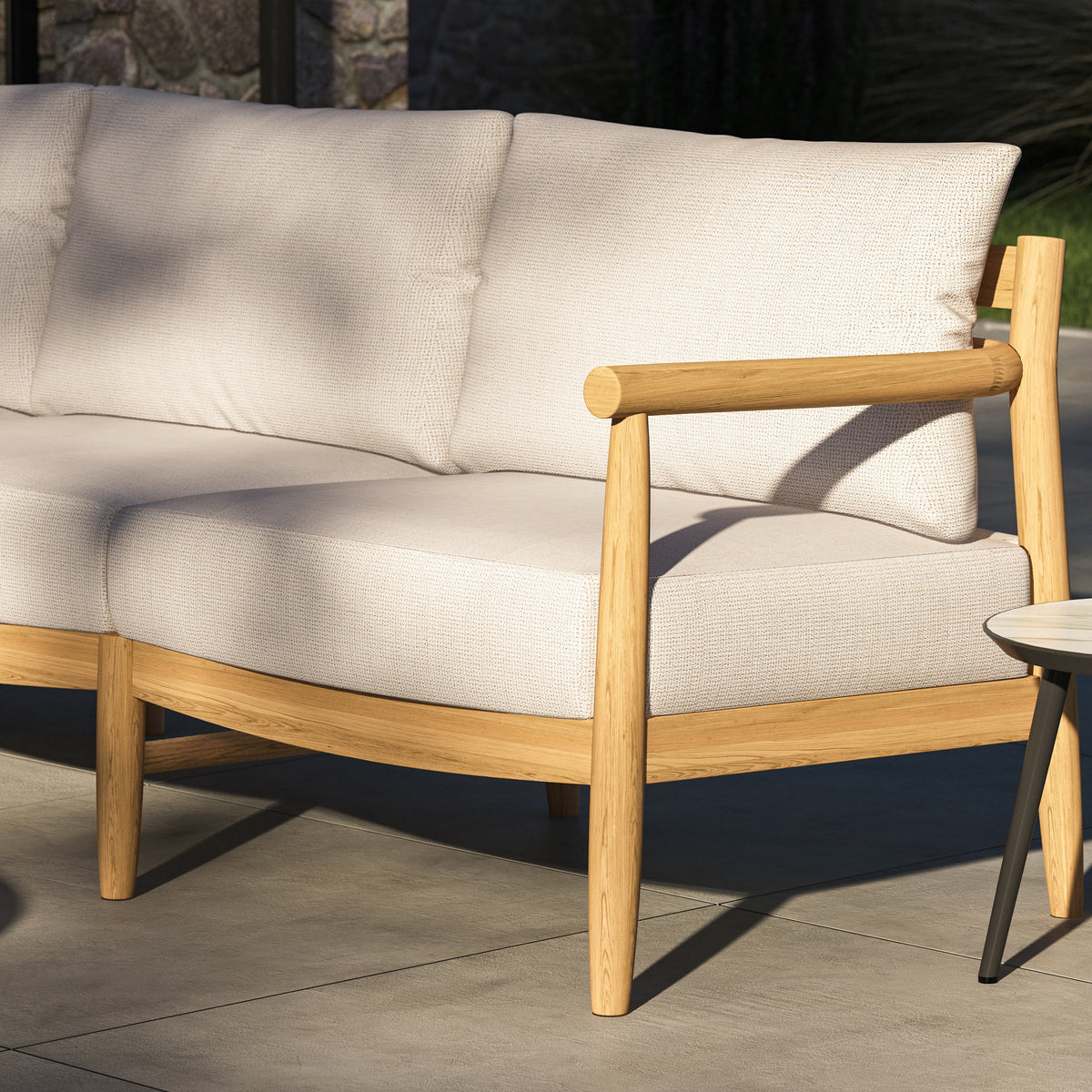 Close detail of the Lido sofa arm and leg showing exposed through joinery in solid teak