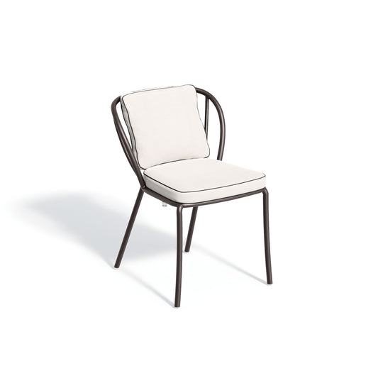 Armless powder coated aluminum dining chair with a light seat pad and low back cushion