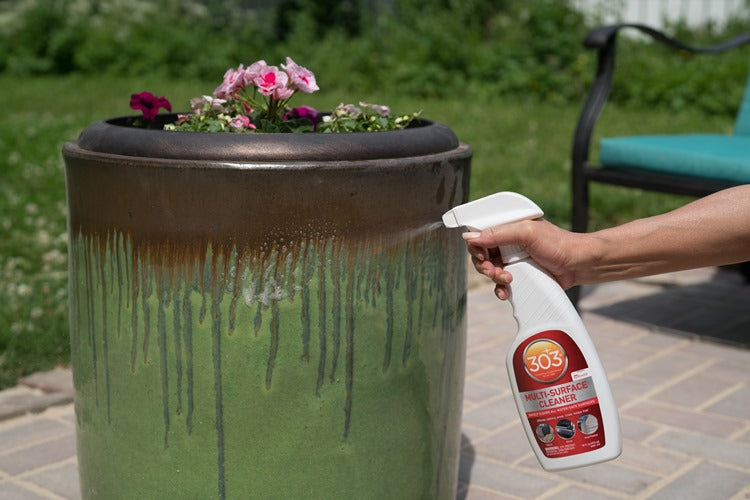 Spraying 303 Multi-Surface Cleaner onto a glazed outdoor planter