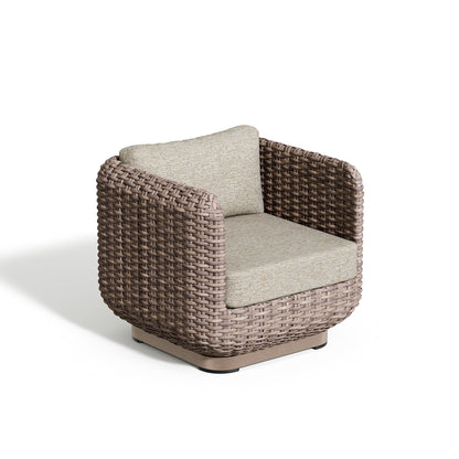 Nomi club chair in greige wicker with Mainstreet Dove cushions, photographed against white