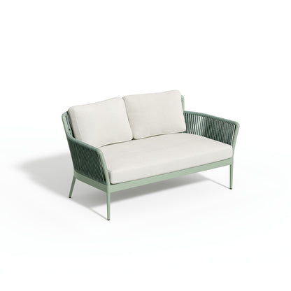 Nette loveseat carrying Bliss Linen cushions on a sage frame, photographed on white