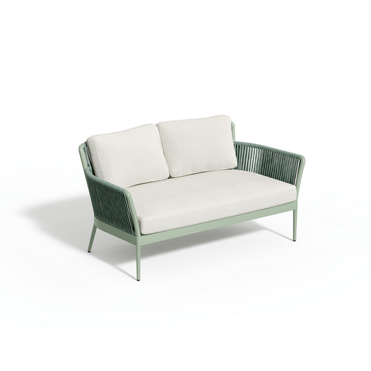 Nette loveseat carrying Bliss Linen cushions on a sage frame, photographed on white