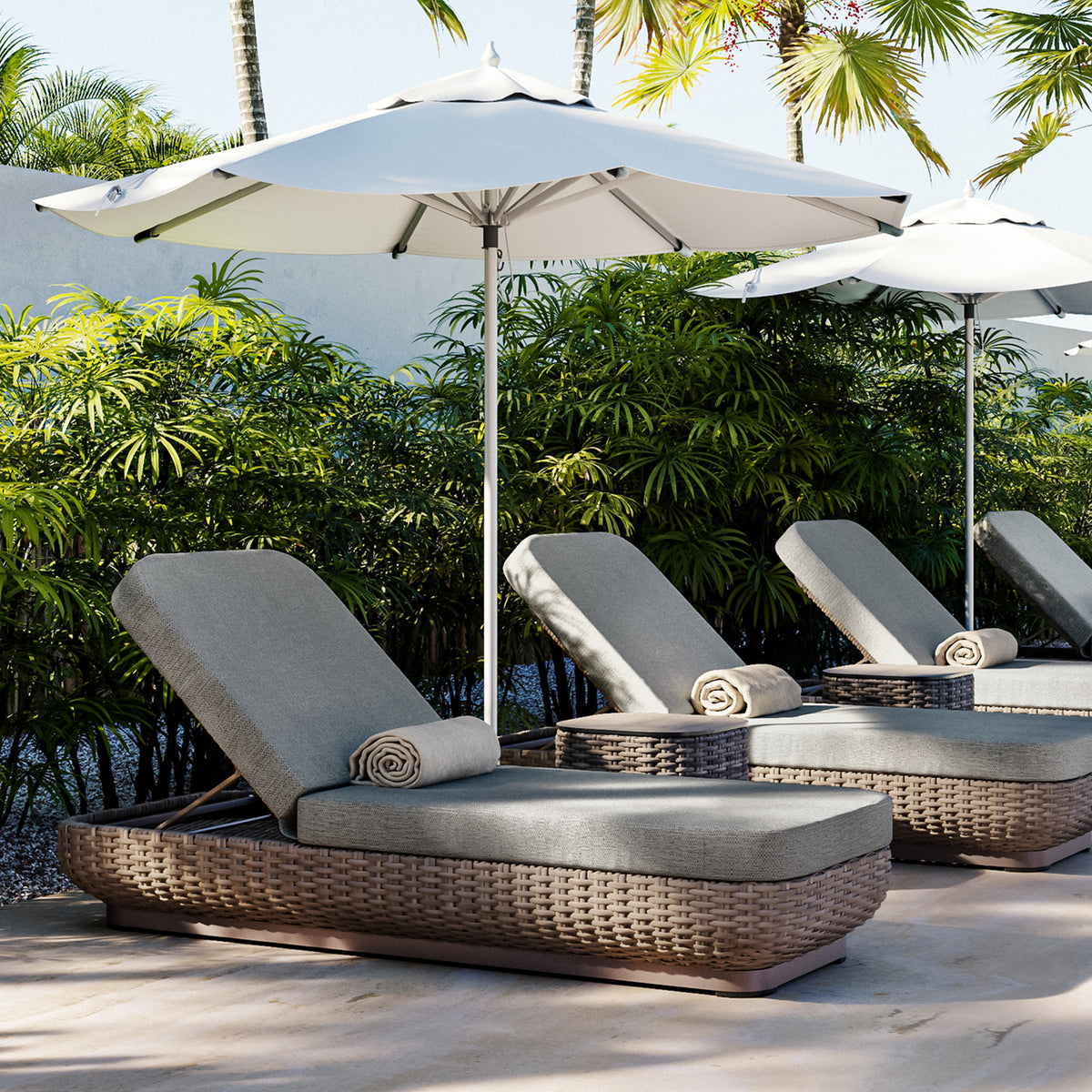 A pair of Nomi chaise lounges with Mainstreet Dove pads beside a pool