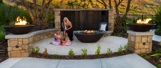 American Fyre Design Calais Oval Fire Table, a chat height oval gas fire table, in an outdoor setting