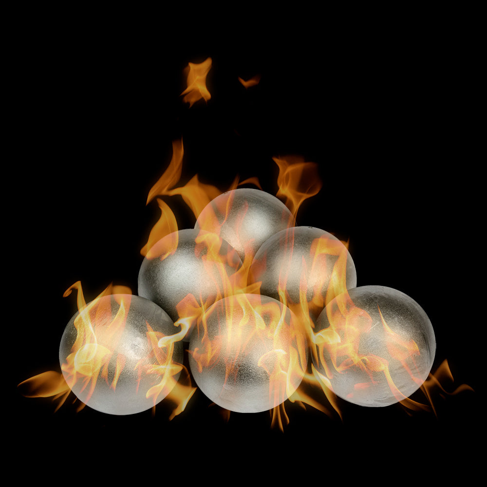 The Outdoor Plus stainless steel fire ball ornaments glowing inside an open flame