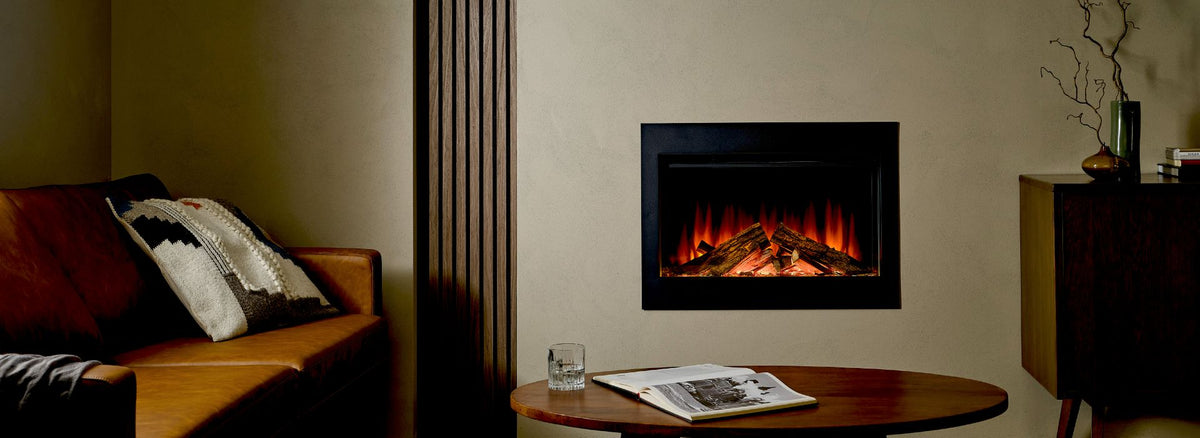 British Fires Ashlett 26 electric fireplace insert with LED flames over real oak logs