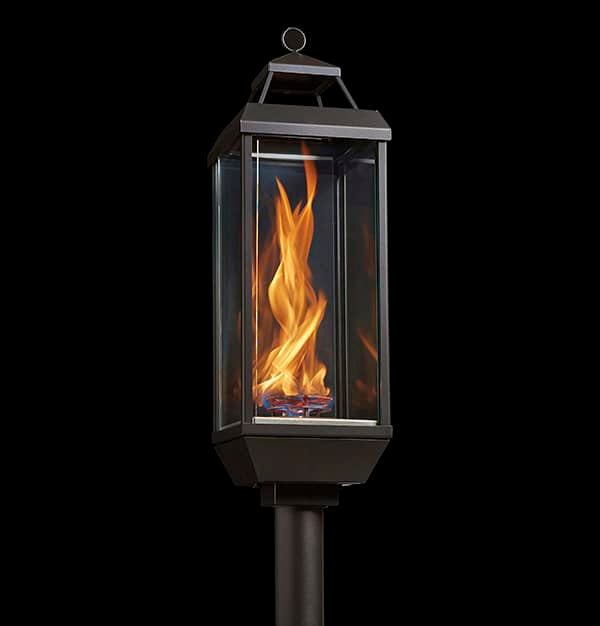 FireGarden Tempest Lantern on a pedestal mount, glass housing with a black frame and cap