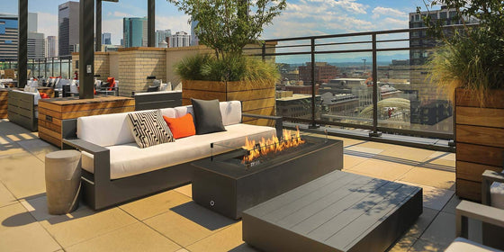 FireGarden 60 inch linear fire pit burner lit in a finished outdoor fire pit
