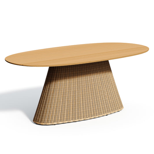 Long oval solid teak dining table on a pale woven trestle base, on a plain white background