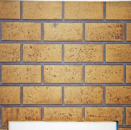 Napoleon DBPX70SS sandstone decorative brick panels featuring light tan masonry texture for a 70-inch Napoleon linear gas fireplace