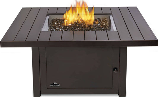 Napoleon square gas fire pit table with dark finish, glass media center, and open flame for outdoor patio use