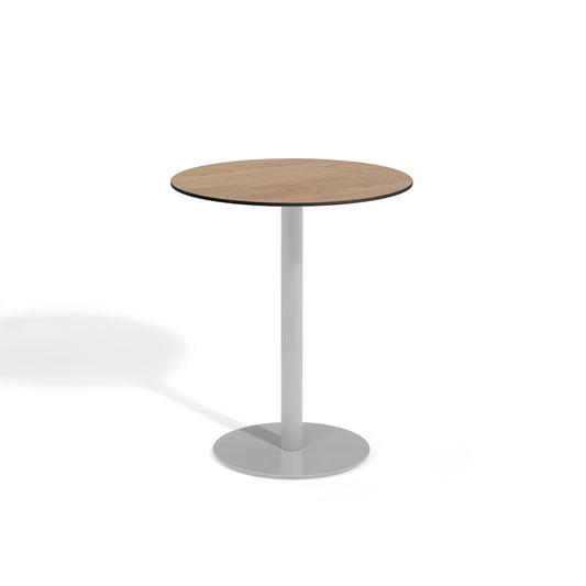 Oxford Garden Travira 36 inch round bar height outdoor table with a high pressure laminate top on a flint grey powder coated aluminum pedestal base, shown on a plain white background