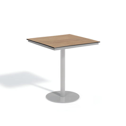 Oxford Garden Travira 38 inch square bar height outdoor table with a high pressure laminate top on a flint grey powder coated aluminum pedestal base, shown on a plain white background