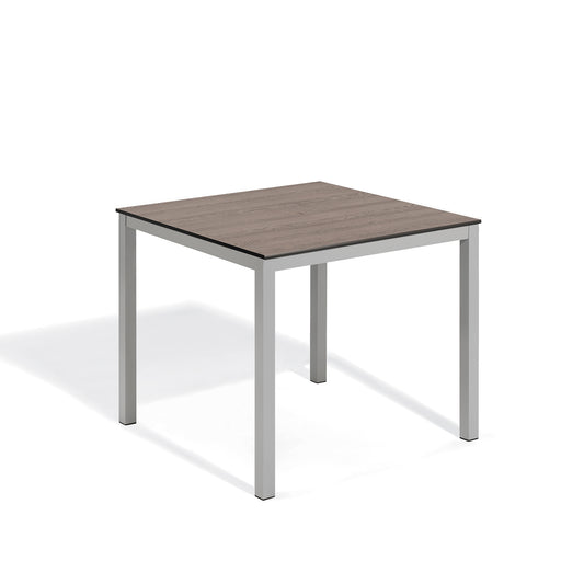Oxford Garden Travira 39 inch square counter height outdoor table with a Marshland Oak high pressure laminate top on a flint gray powder coated aluminum base, shown on a plain white background