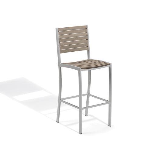 Oxford Garden Travira bar height outdoor chair with a slatted seat and a footrail on a flint grey powder coated aluminum frame, shown on a plain white background