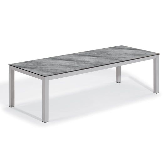 Oxford Garden Travira 103 inch rectangular outdoor dining table with a high pressure laminate top on a flint grey powder coated aluminum frame, shown on a plain white background