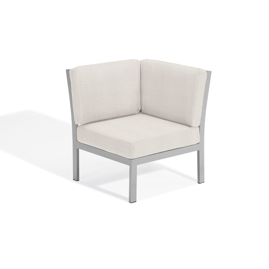 Travira modular corner seat with Bliss Linen cushions on a flint powder coated aluminum frame