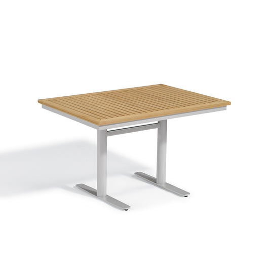 Oxford Garden Travira rectangular outdoor bistro table with a natural wood grain Tekwood top on a flint gray powder coated aluminum base, shown on a plain white background