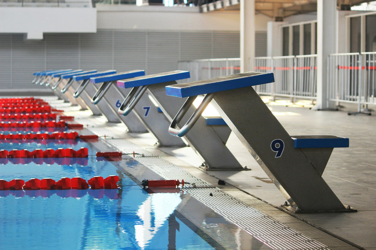 Starting blocks along the edge of a competition swimming pool