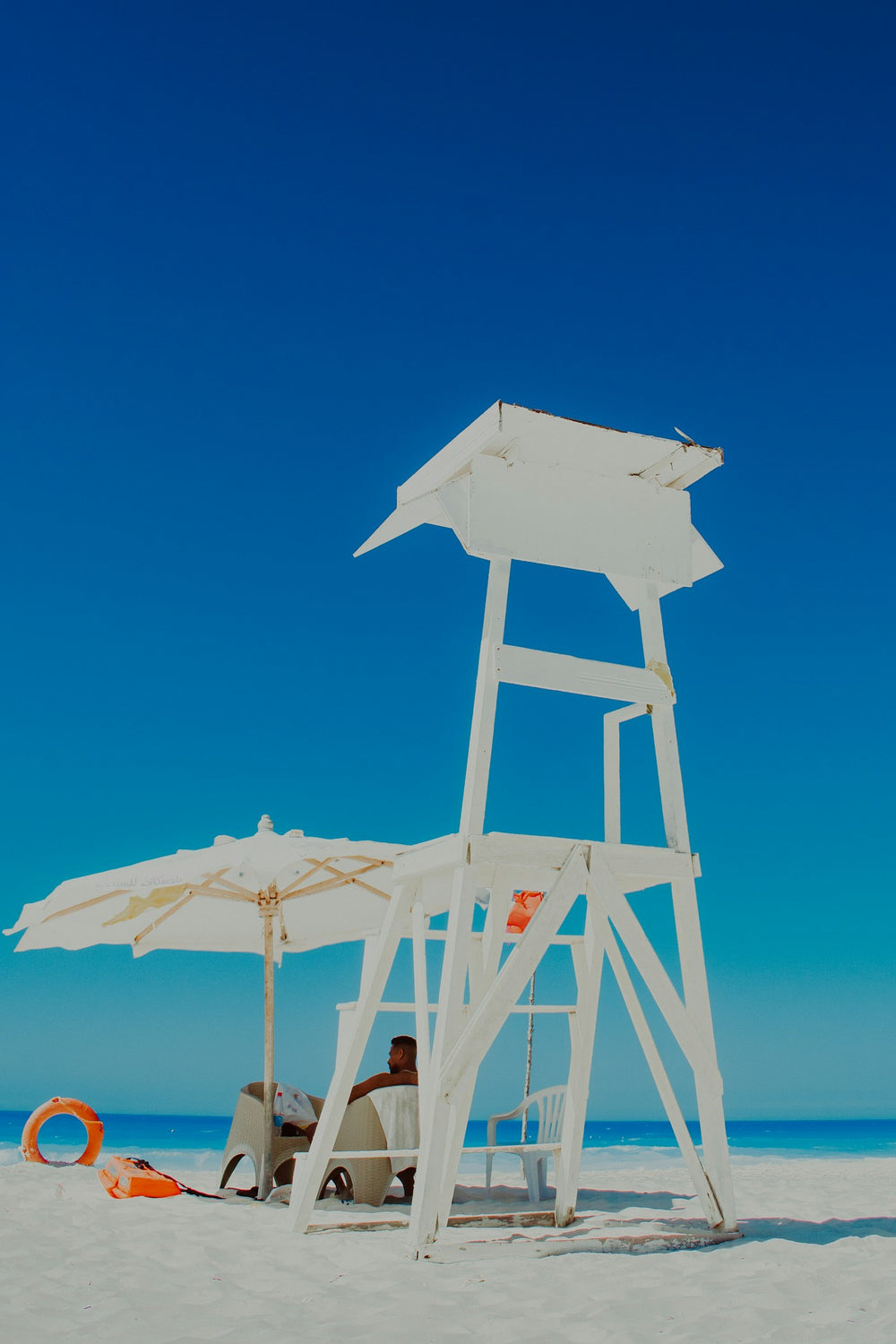 A lifeguard stand with a ring buoy mounted on it