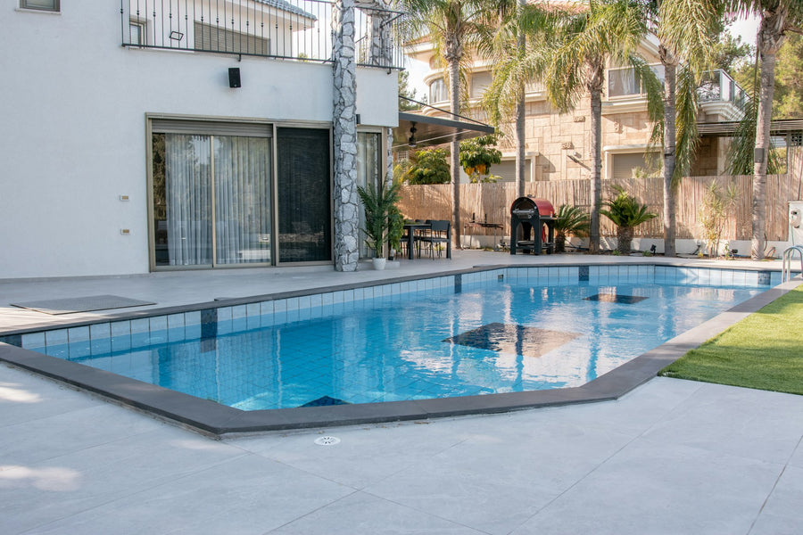 Backyard swimming pool in daylight