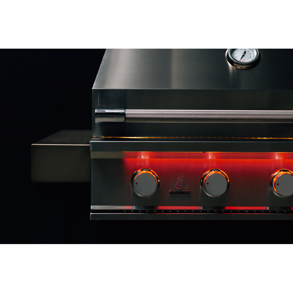Lit control knobs on a True Flame built-in gas grill showing which burners are on